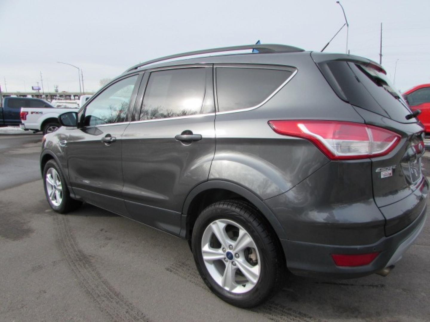 2015 Gray /Tan Ford Escape SE (1FMCU9G96FU) with an 2.0 I4 Ecoboost turbo engine engine, 6 speed automatic transmission, located at 4562 State Avenue, Billings, MT, 59101, (406) 896-9833, 45.769516, -108.526772 - 2015 Ford Escape SE 4WD 2.0 Ecoboost Turbo 4 cylinder engine - 6 speed automatic transmission - 4WD - 151,468 miles $256 per month - payment example based on $1000 cash or trade down - 36 months at 7.99 percent APR - on approved credit SE package - air conditioning - tilt and steering wheel - Photo#1